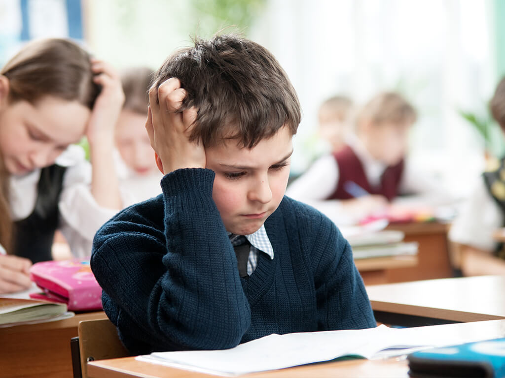 child looking anxious doing mathematics