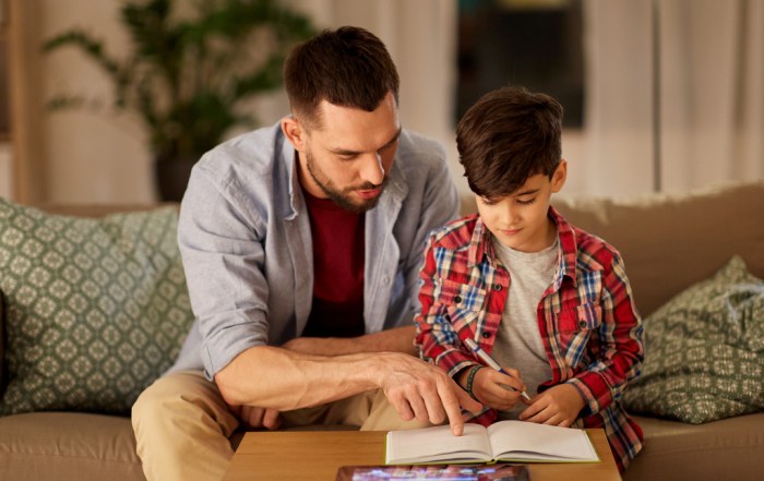father helping his son with home learning