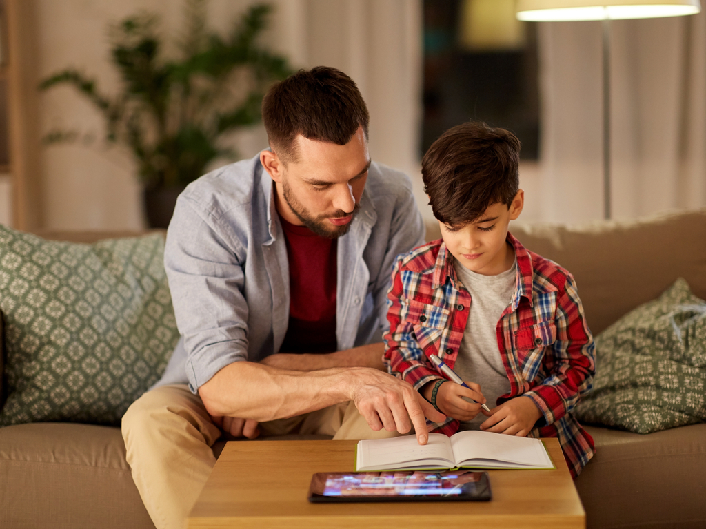 father helping his son with home learning