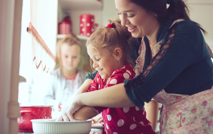 mother cooking at home with her daughter