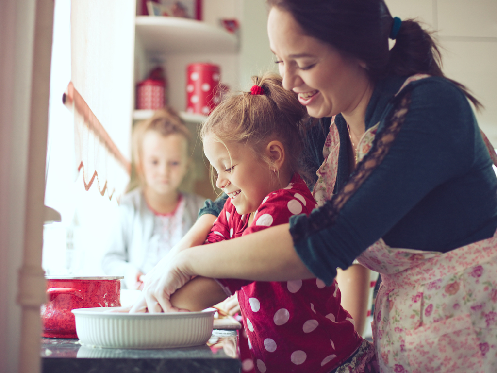 mother cooking at home with her daughter
