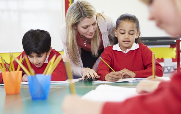 teacher helping young girl with formative assessment
