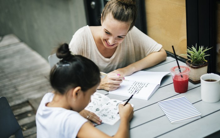 mother helping daughter do her homework