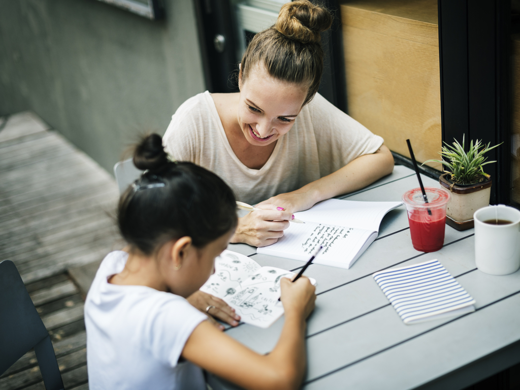 mother helping daughter do her homework