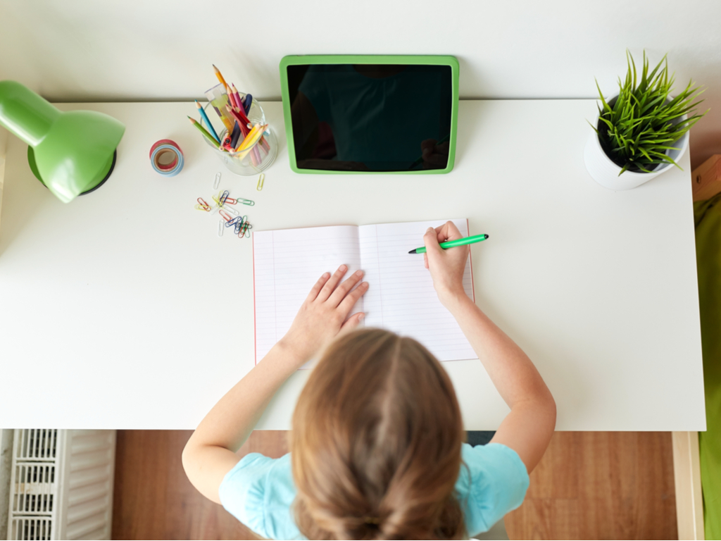 motivated young girl working at her desk